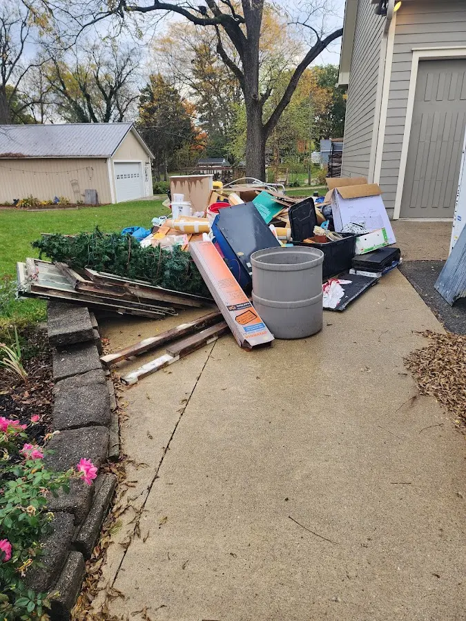 Dumpster being loaded with debris for Estate Cleanout Dumpster Rental in Belle Chasse